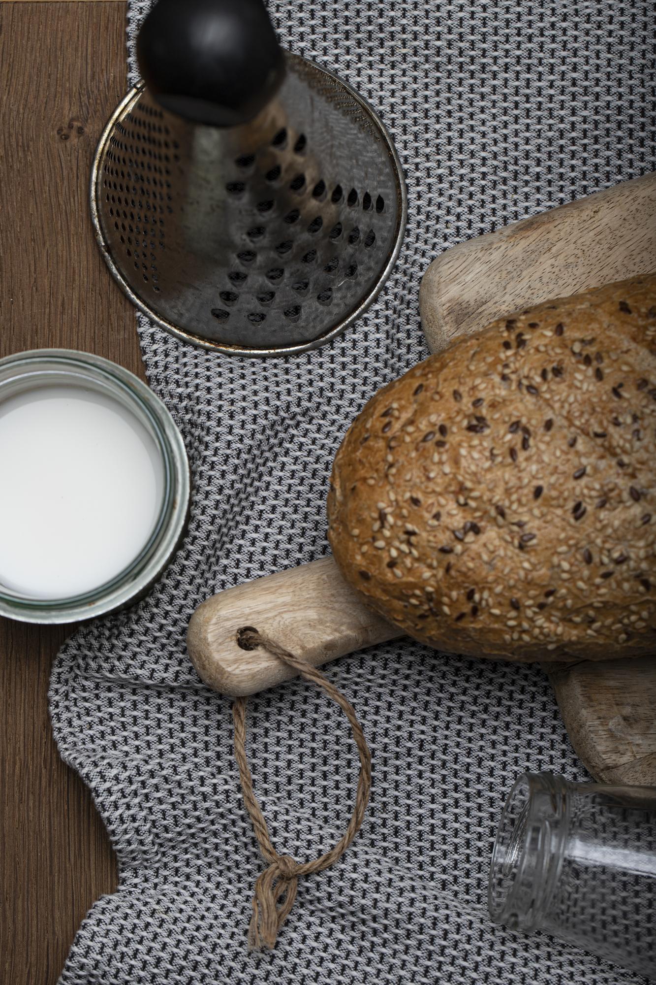 Artisan bread and tools on wooden table