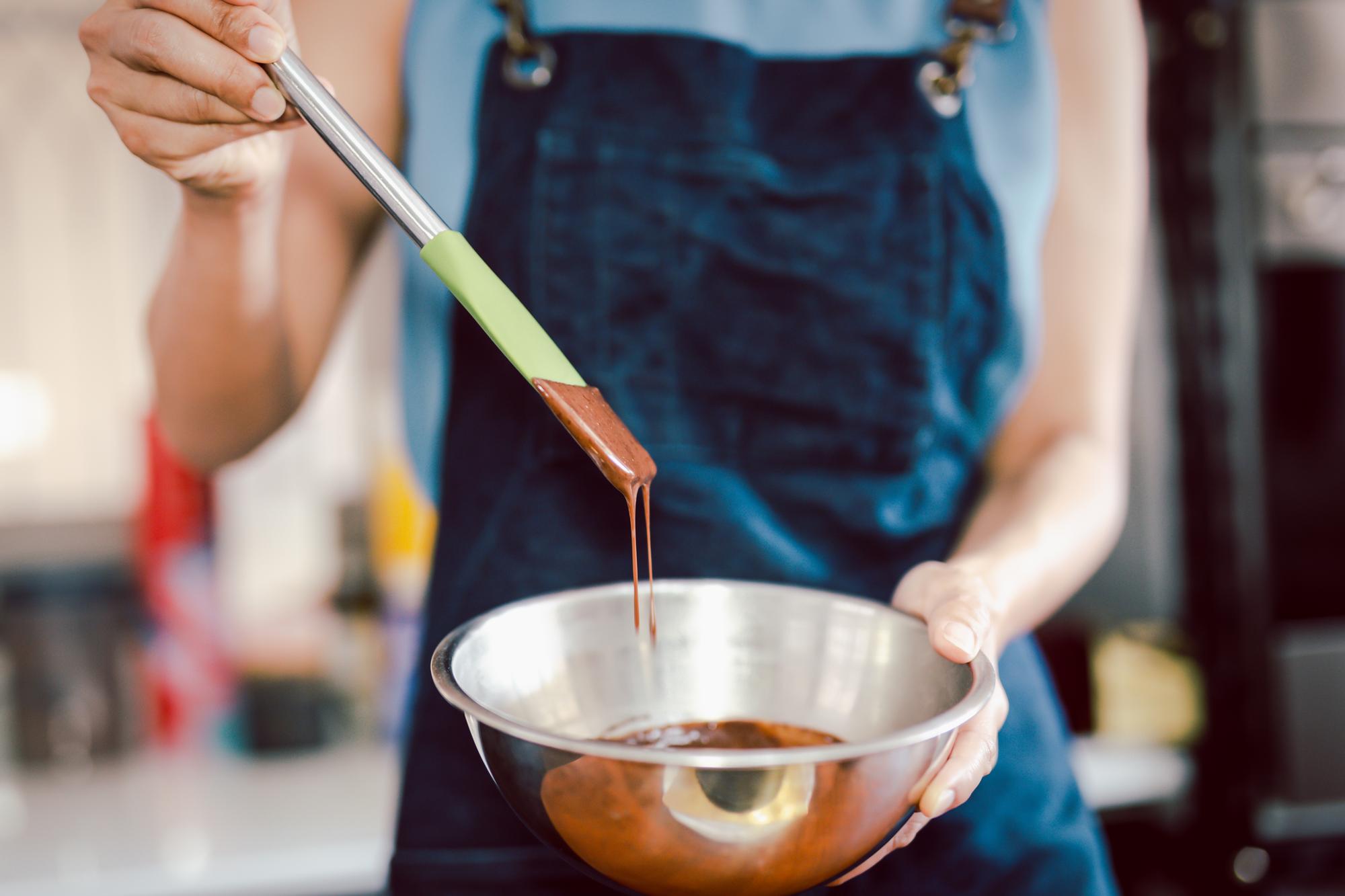 Chef testing sauce in kitchen